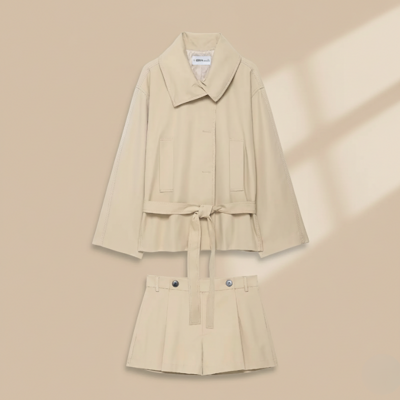 Flat lay of beige blazer and shorts set showing coordinated pieces and tailored design