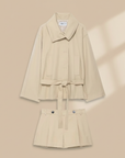 Flat lay of beige blazer and shorts set showing coordinated pieces and tailored design