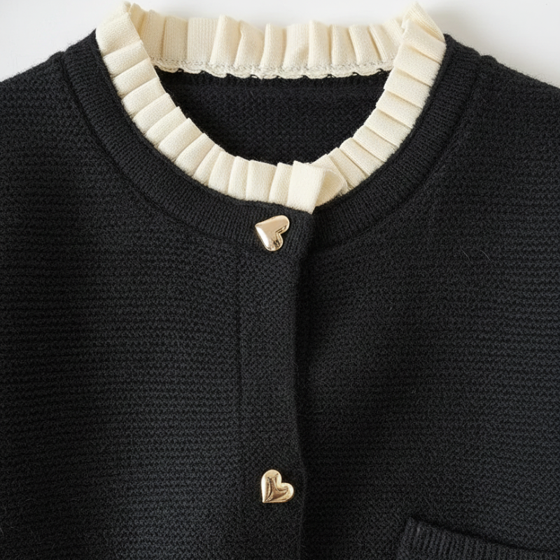 Model trägt einen navyfarbenen Cardigan mit Kontrastbesatz und eleganter Passform in einer klaren Studioaufnahme.