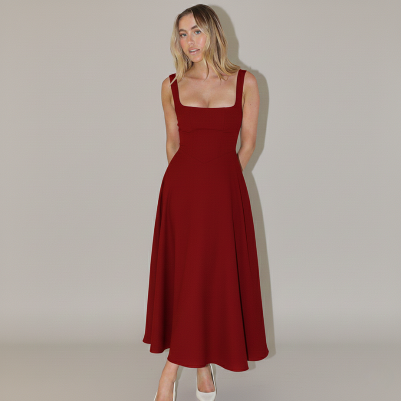 Model präsentiert ein rotes Damen-Midikleid mit fließendem Rock vor hellem Hintergrund.