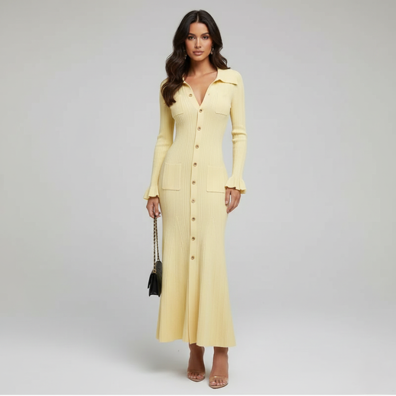 Model trägt ein langes gelbes Strickkleid mit Knopfleiste und eleganter Silhouette in einem minimalistischen Studio.