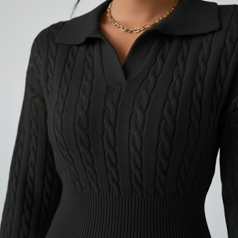Nahaufnahme des schwarzen Pullovers mit gerippter Stoffstruktur und sauberer Verarbeitung.