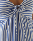 Close-up of a striped sundress showing knot-front neckline, gathered bust design, and soft textured fabric.